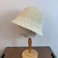 Detail of cream hollow knit bucket hat with diamond crochet patterns on mannequin head - M / Milky White