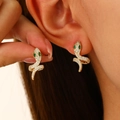 Golden snake hoop earrings with white zircon pave and green stone eyes worn by model - 14K Gold Hoop (DZ-184)