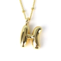 Detailed view of high-polished gold H-letter balloon pendant on thin twist chain - Letter H
