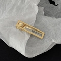 Macro shot of minimalist gold rectangular hollow metal hair clip with a polished finish - Gold Hollow Rectangle Style