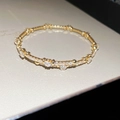 Macro detail van 18K gouden armband met pavé gezette zirkoon en hartjes - Hart Open Stijl / Goud - Hart