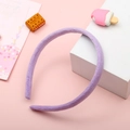 Handmade purple plush headband with soft fabric finish on a pastel background - Purple