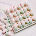 Macro detail of pink and green gradient resin bow beads with high gloss finish - 25mm / Gradient Blue Pink
