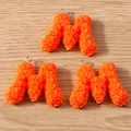Close-up of orange letter M charms with 3D rose textures for DIY jewelry crafts - Letter M / 10 Pieces Pack / Orange