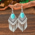 Detail of vintage teardrop earrings with turquoise stones and fringes on wooden branch - Irregular Concentric Rings (S1691)
