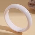 Macro side view of a glossy white spiral textured minimalist open metal bracelet - White