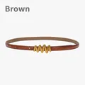 Slim brown leather belt for women featuring a wavy gold buckle and adjustable holes - Brown
