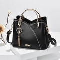 Chic black handbag with contrast white stitching, gold ring handle and heart tassel charm - Black