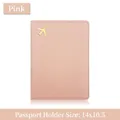 Pink lychee grain leather passport holder with a gold airplane icon and card slots - Pink