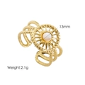 Detail of gold twisted band ring with sunburst motif and white pearl bead center - White Shell