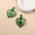 Macro shot of two green glass heart pendants with gold glitter and floral details - Green (Type B)