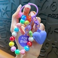 Portachiavi colorato con perle iridescenti e ciondolo a cuore viola per borse - Ciondolo a Cuore con Perline Colorate / Viola