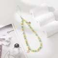 Close-up of beaded phone strap with green and yellow beads and gold star charms - Grass Green