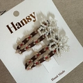 Detailed view of floral embroidery and pearl flowers on brown mesh BB hair clips - Coffee