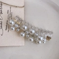 Detailed macro view of a clear spiral hair tie decorated with elegant white faux pearls - White Beads/Faux Pearl