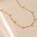 Macro shot of 18K gold plated stainless steel beads and elegant thin chain detail - Beaded Necklace