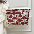 Handheld cream canvas makeup bag with red mushroom print and top zipper closure - Magic Mushroom Red