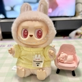Labubu plush doll wearing a yellow knitted sweater and rabbit ear hat with pink chair - Yellow Toner Bubble Shirt / First And Second Generation Keychains Are Compatible With La Cloth Dolls. Dolls Not Included.