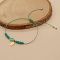 Adjustable green braided evil eye bracelet featuring a gold Hamsa hand charm and beads - Green Hamsa Eye Bracelet (C-B220068C)
