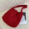 Solid red fuzzy boucle tote bag with single shoulder strap on white plush background - Burgundy