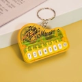 Mini piano musical keychain in translucent yellow finish with functional white buttons - Bag Packaging / Transparent Yellow