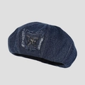 Close-up of dark blue denim beret with silver metal butterfly patch and frayed texture - M (56-58cm) / Denim Blue