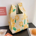 Detailed close-up of yellow daisy pattern on cream-colored knitted bucket tote bag - Yellow Sunflower