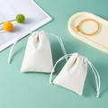 White velvet drawstring jewelry pouch with soft texture on light mint green surface - Drawstring Style - Off-white; 8*10cm Velvet Bag