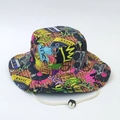Detail of graffiti print bucket hat featuring retro radio patterns and adjustable chin cord - Eighties Retro Style