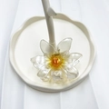 Transparent flower hair claw clip with amber yellow center on a white wavy tray - Yellow (Pearlescent Sun Flower)