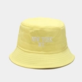 Detailed view of New York embroidery on a yellow cotton bucket hat with neat stitching - M (56-58cm) / Yellow