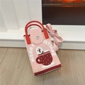 Detail der rosa gestrickten Weihnachts-Mini-Tasche mit Schneemann-Motiv und rotem Griff - Teetasse Schneemann Rosa
