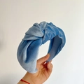 Detail of blue velvet knotted headband showing soft fabric texture and thick padded style - Blue
