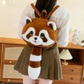 Cute brown raccoon plush backpack with striped tail and adjustable straps shown on back - Large Backpack Style
