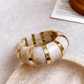Detailed shot of cream resin marble bangle with gold metallic accents on linen background - 6# Bangle-Gold-Cream White