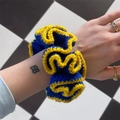 Handmade knitted scrunchie in royal blue and yellow featuring a ruffled crochet design - Blue with Yellow Edge
