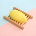 Handmade yellow milk soap placed on a minimalist light wood draining rack stand - 110g Thai-style Lemon Soap