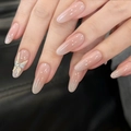 Detail of nude pink press-on nails with 3D white bow and sparkling rhinestone accent - By1540 Fleeting Glimpses / Glue Type