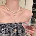 Natural pearl necklace with white camellia pendant and gold tassel worn by model - Style AC-007-Freshwater Pearl Camellia Necklace