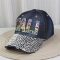 Detailed view of dark denim baseball cap with rhinestone CALI lettering on a woven mat - No.16/Dark Blue Denim/CALI Letters