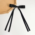 Detail shot of long black satin ribbon hair bow clip with silky finish and draping tails - Long Streamer Style (Single) / Black