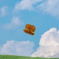 Brown pretzel-shaped acetate hair claw clip shown against a sunny blue sky backdrop - Small Pretzel