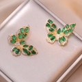 Detailed view of butterfly earrings with green zircon stones on gold metal finish - Green Butterfly Style (E0858)