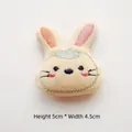 Close-up of plush cartoon rabbit head DIY accessory with pink details, H 5cm x W 4.5cm - Yellow Rabbit