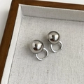 Minimalist silver geometric ball earrings with high-polish finish on a woven background - Silver