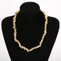 Macro shot of yellow natural crystal stone necklace beads on black velvet jewelry display - Yellow Citrine