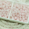 Macro shot of 6mm pink ice-cracked glass beads in a ceramic tray for DIY jewelry making - Jade Texture Light Pink (6mm)