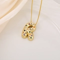 Detailed macro view of gold letter R pendant necklace with colorful inlaid zircon stones - Letter R