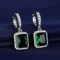 Elegant emerald cut green gemstone earrings with silver diamond setting on blue cloth - Green Diamond Earrings Led-112
