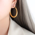 Chunky gold hollow twisted hoop earrings with spiral texture shown on model - Spiral Texture Style (F879)